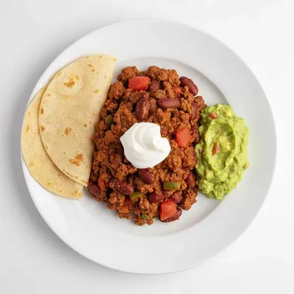 Beef chilli con carne with corn tortilla and guacamole